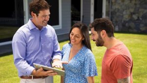 Couple being shown projected savings on energy bills expected after installing a Solahart solar power system