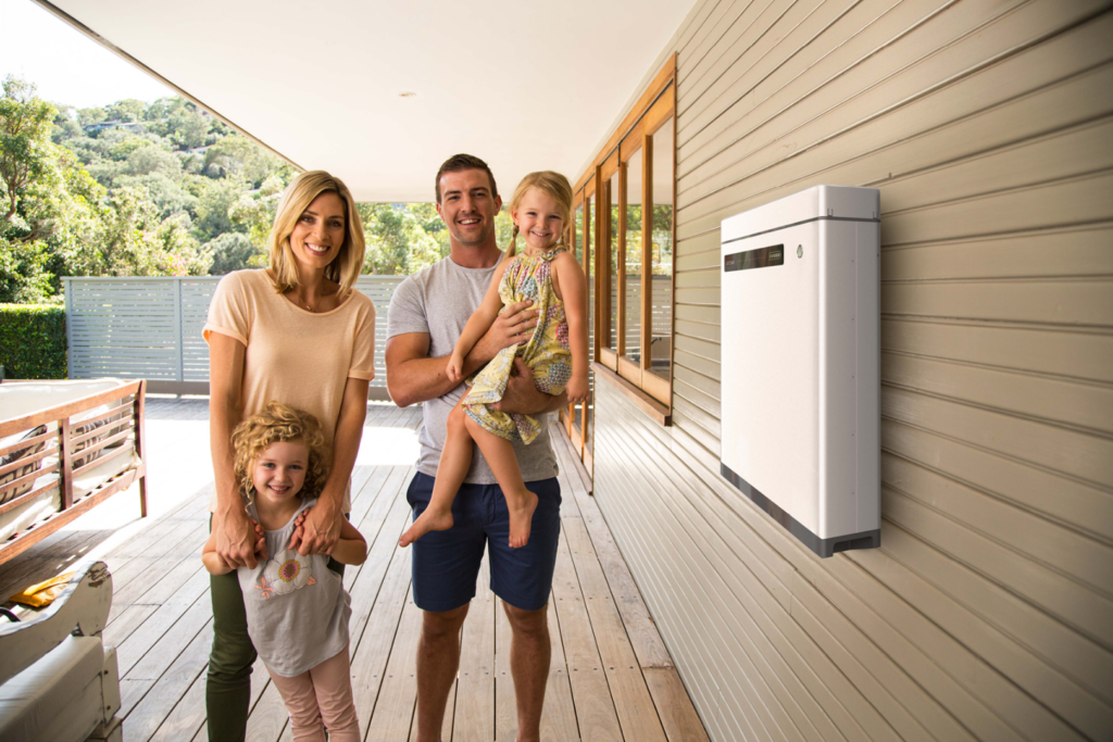 Family with two kids standing next to GoodWe